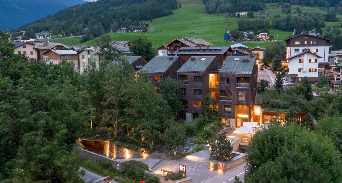 Hotel moderno immerso nel verde, con vista sulle montagne e architettura contemporanea.